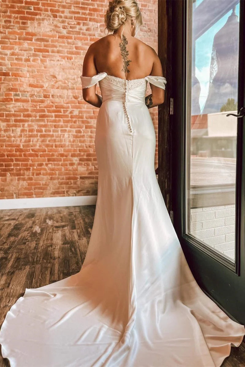 Back view of the mermaid off-shoulder bridal gown, showcasing its long train.