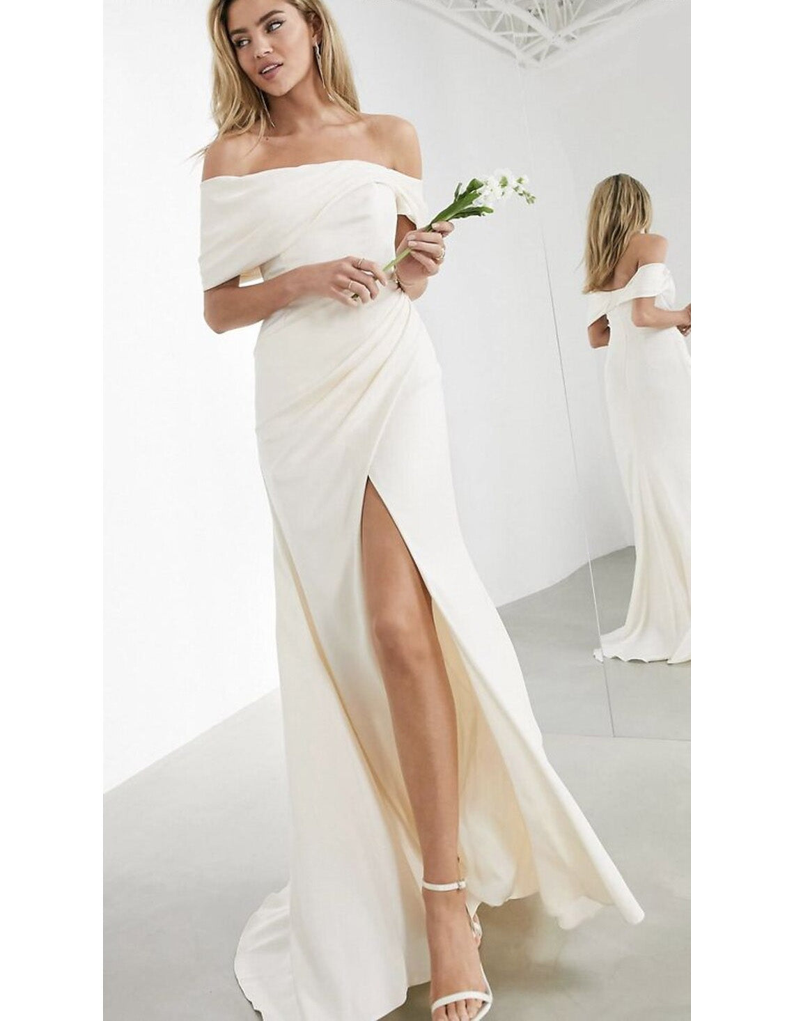 Elegant mermaid wedding dress with off-shoulder neckline and ruched details.
