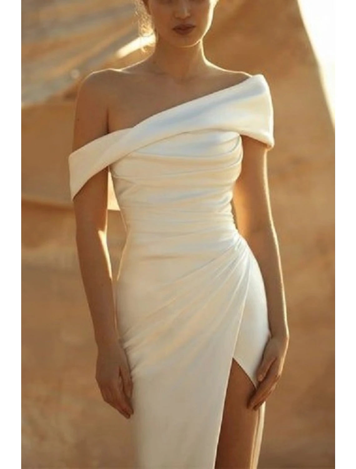 Side view of a charmeuse off-shoulder wedding dress.
