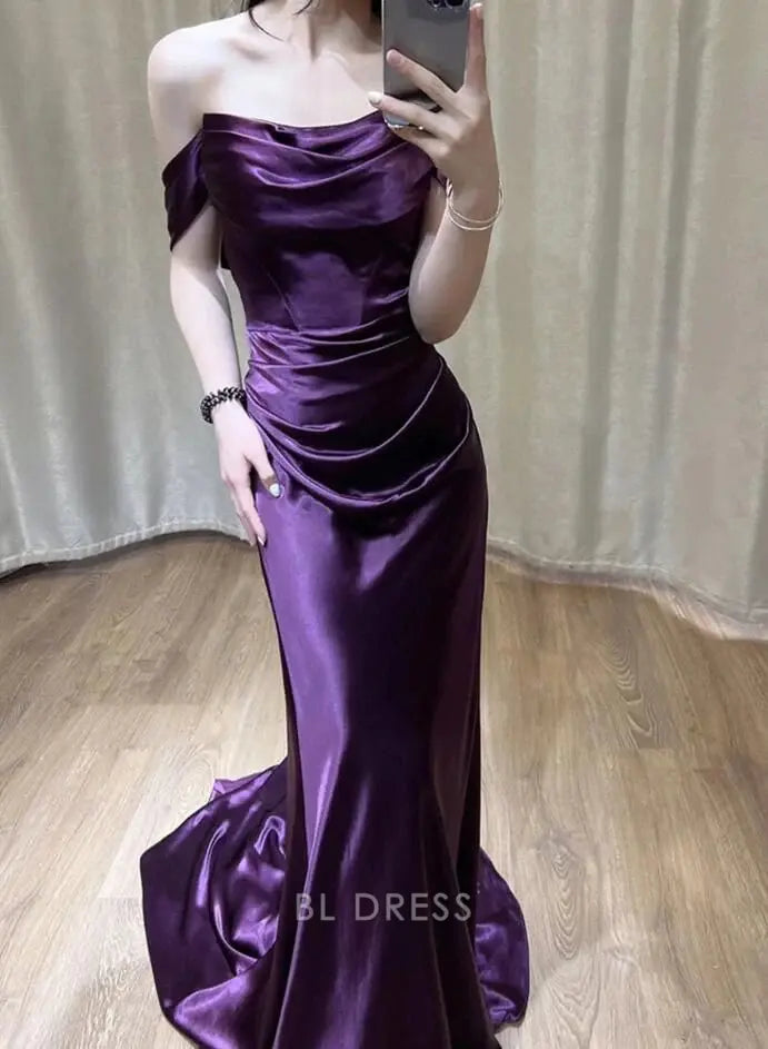 Purple mermaid off-shoulder satin evening gown with flowing skirt.