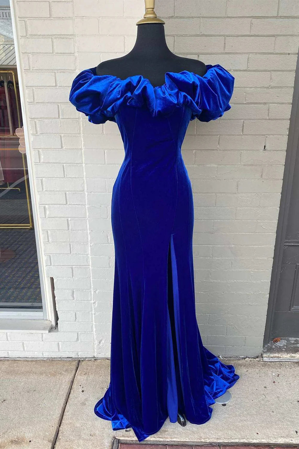 Elegant mermaid off-shoulder ruffled long prom dress in a formal setting.