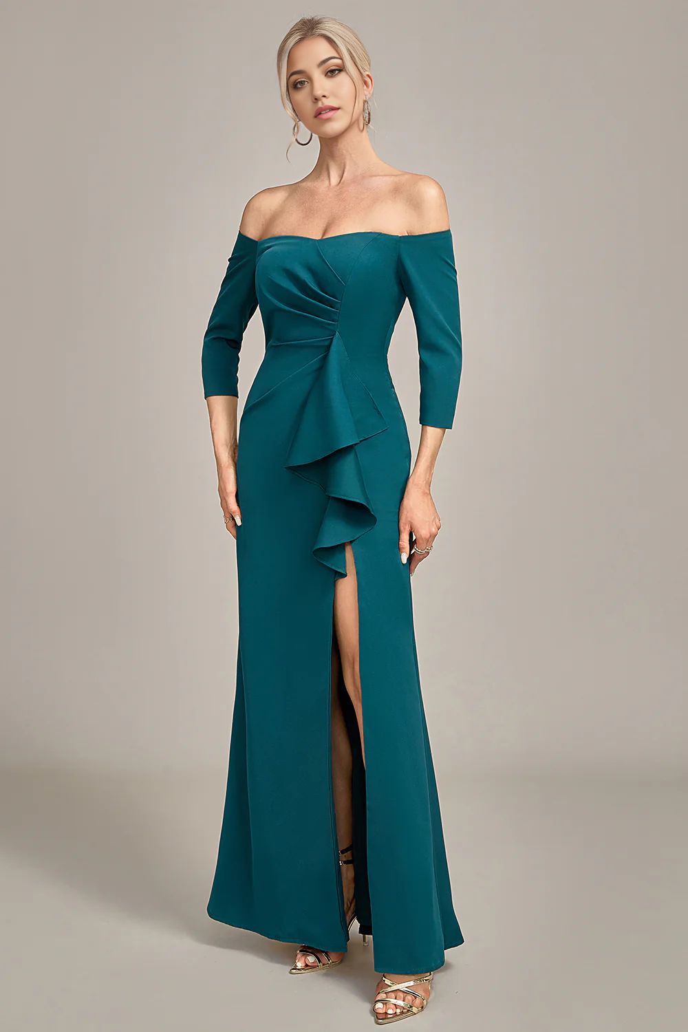 Woman posing gracefully in a mermaid off-shoulder formal dress.