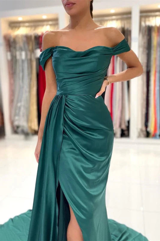 Side view of the dark green mermaid dress, highlighting the leg split and ruffles.