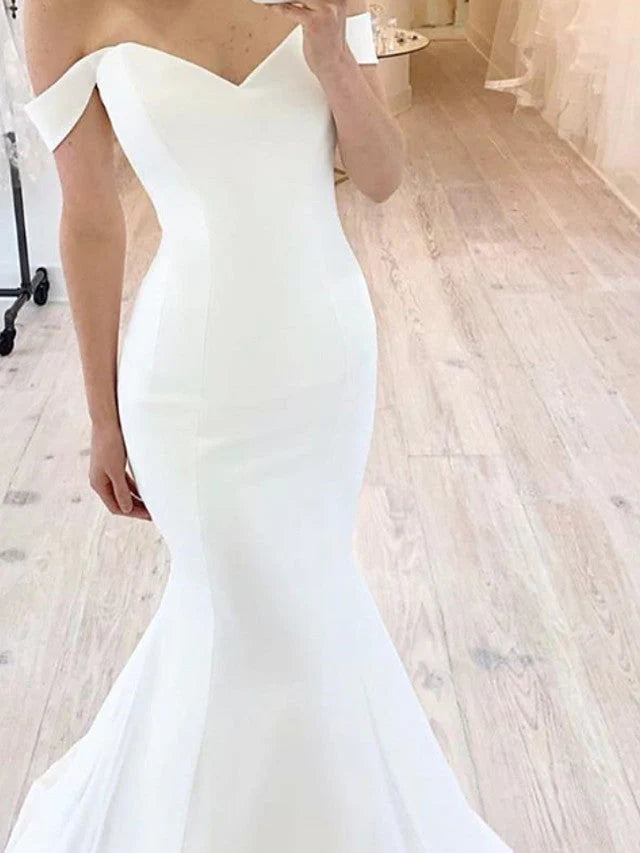 Bride wearing a luxurious off-shoulder mermaid satin gown.