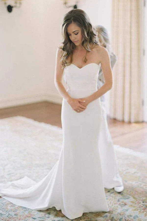 Front view of an elegant white mermaid wedding gown with an off-shoulder sweetheart neckline.