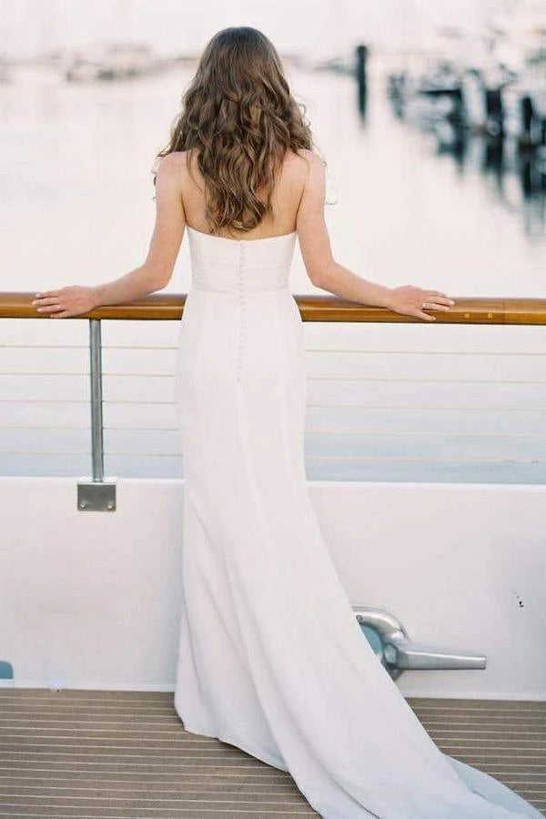 White mermaid bridal dress, showcasing the flattering silhouette and elegant train.