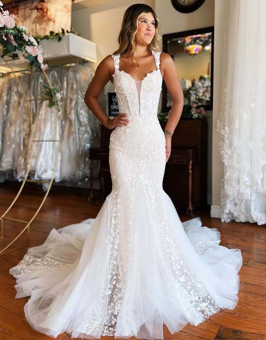 Elegant white mermaid wedding dress with off-shoulder neckline and long train.