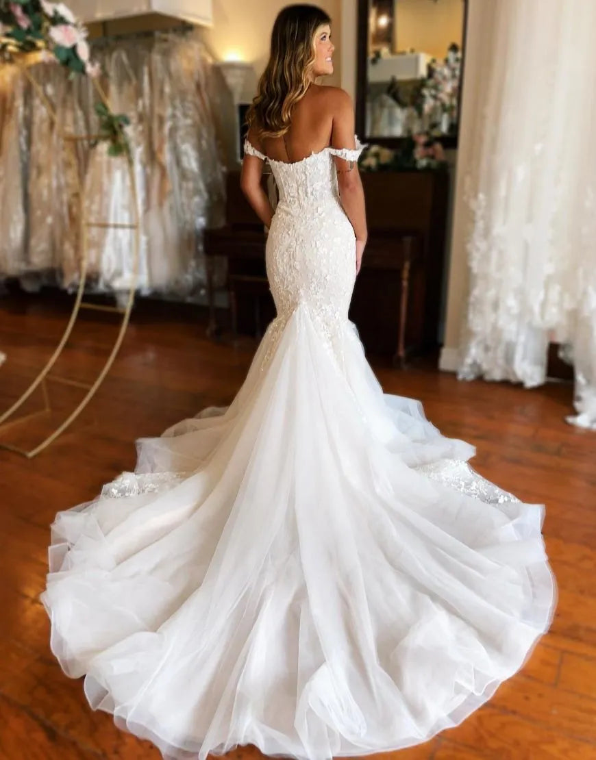 Back view of a white mermaid wedding dress showing the court train.