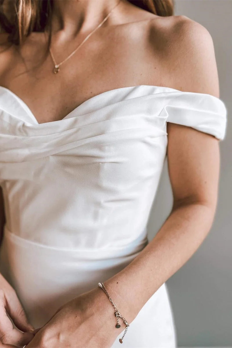Close-up of the off-shoulder neckline and trumpet skirt detail.