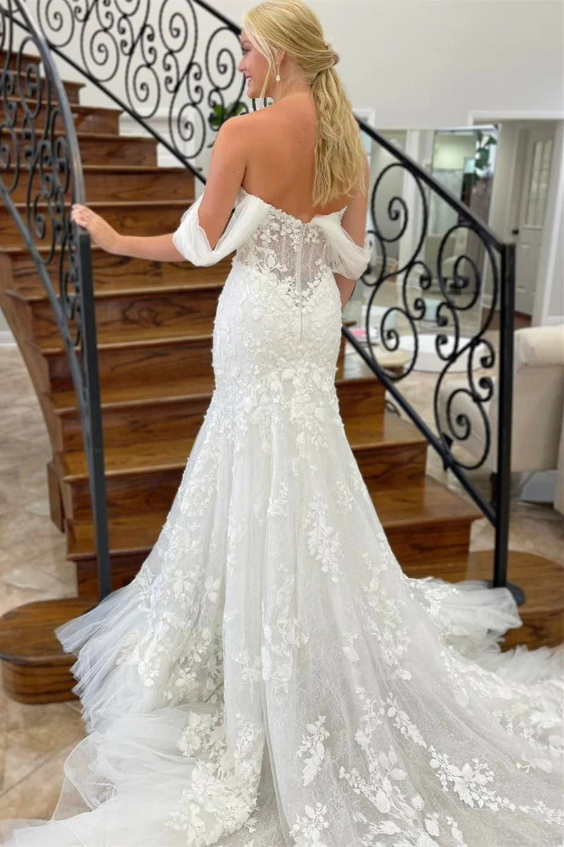 Side view of the bride in the off-shoulder mermaid gown.