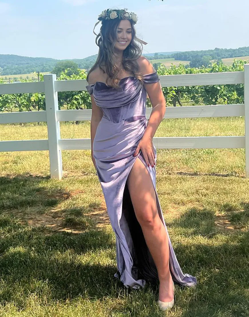 Purple velvet mermaid formal dress with off-shoulder neckline and ruched corset detail.