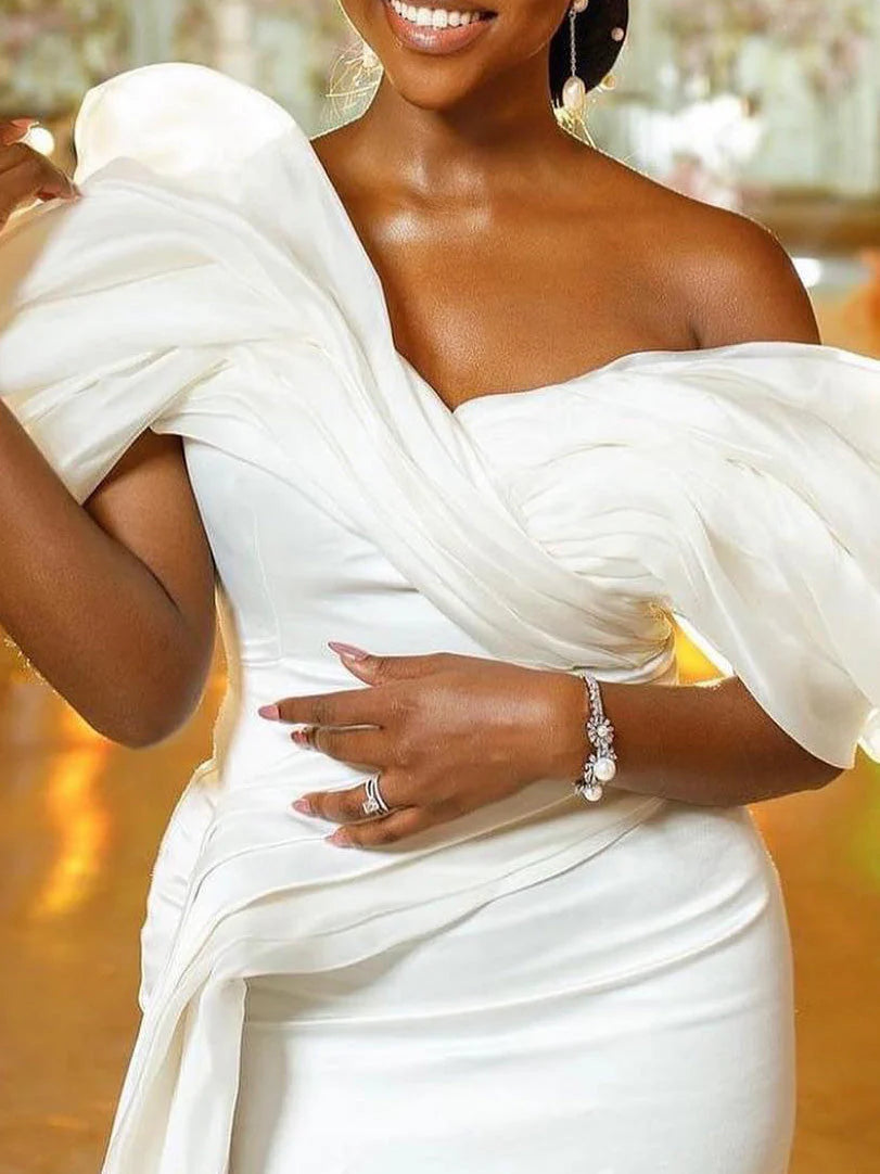 Elegant mermaid off-shoulder wedding dress with a sweeping skirt.