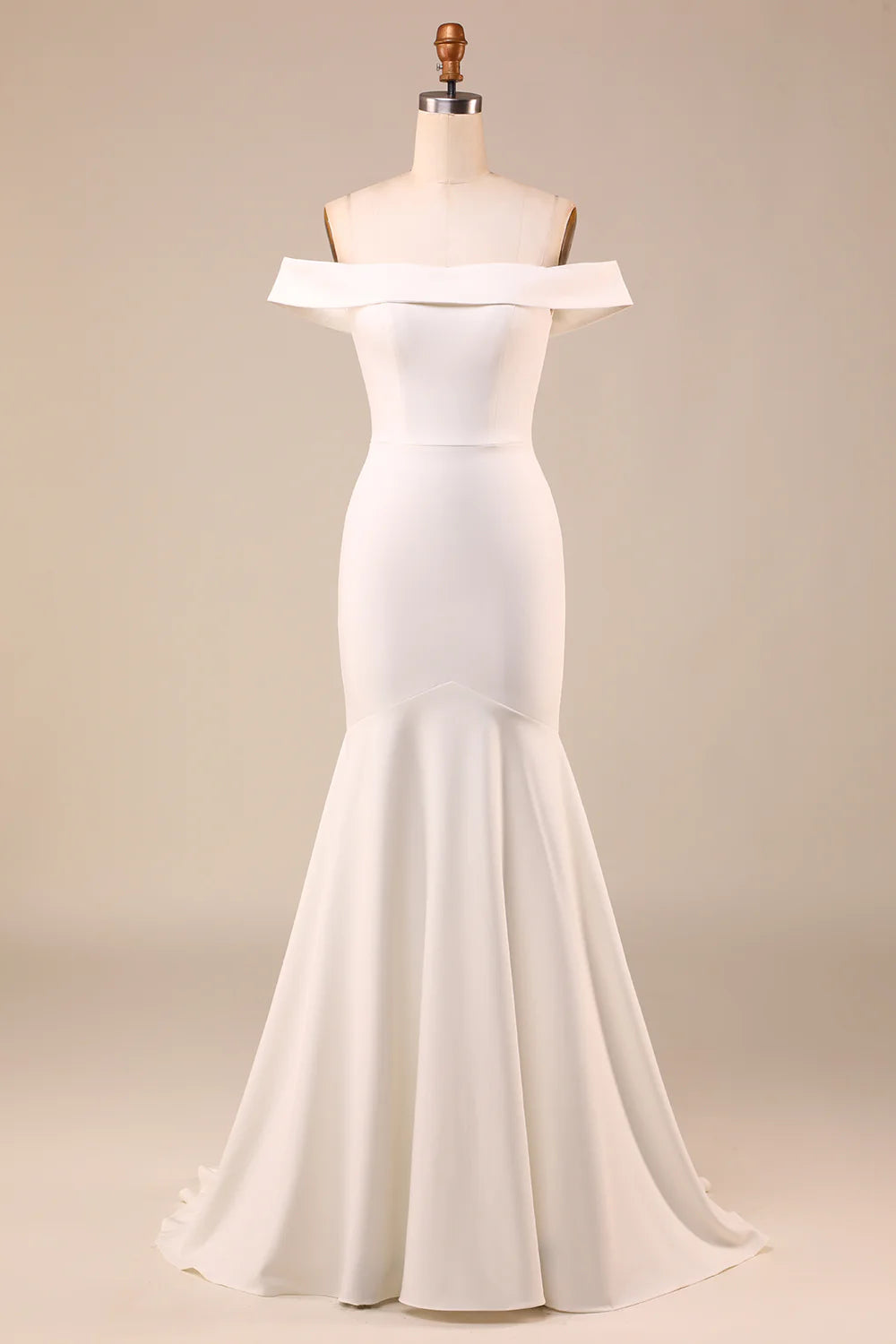 Front view of an elegant ivory mermaid off-shoulder wedding dress with a bownot detail.