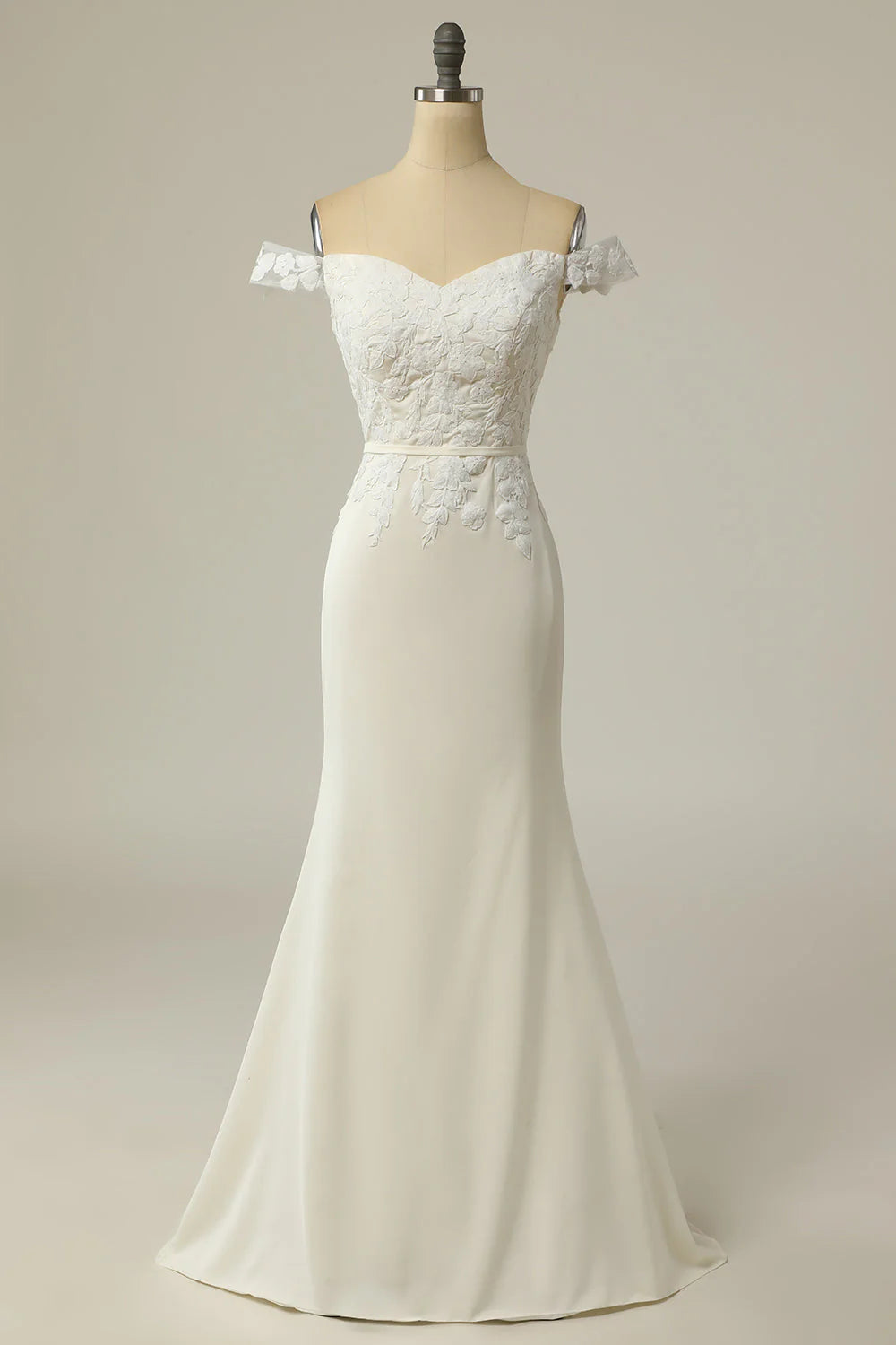 Full view of an elegant mermaid off-shoulder wedding dress with appliques.