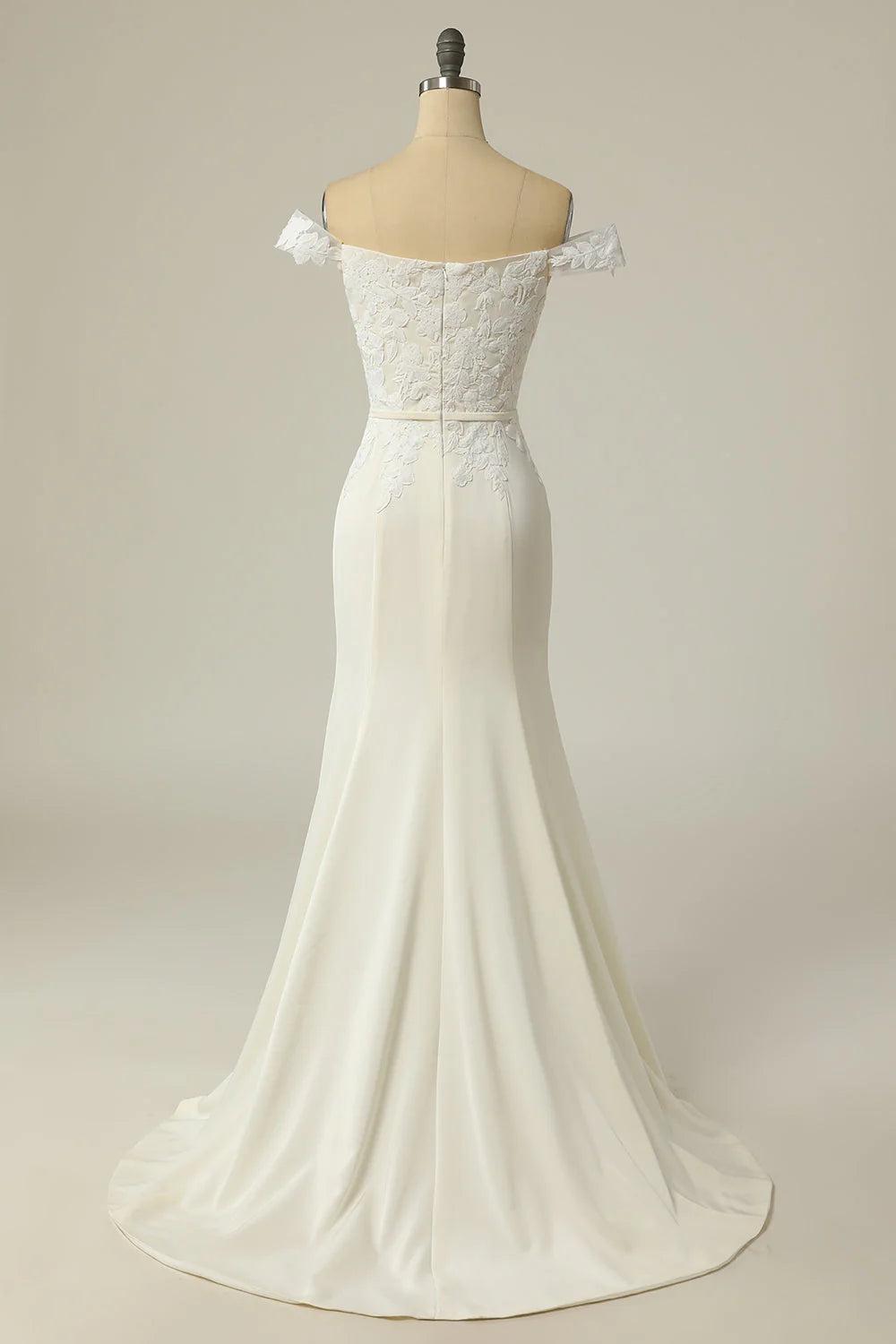 Close-up of delicate appliques and the off-shoulder neckline on the wedding dress.