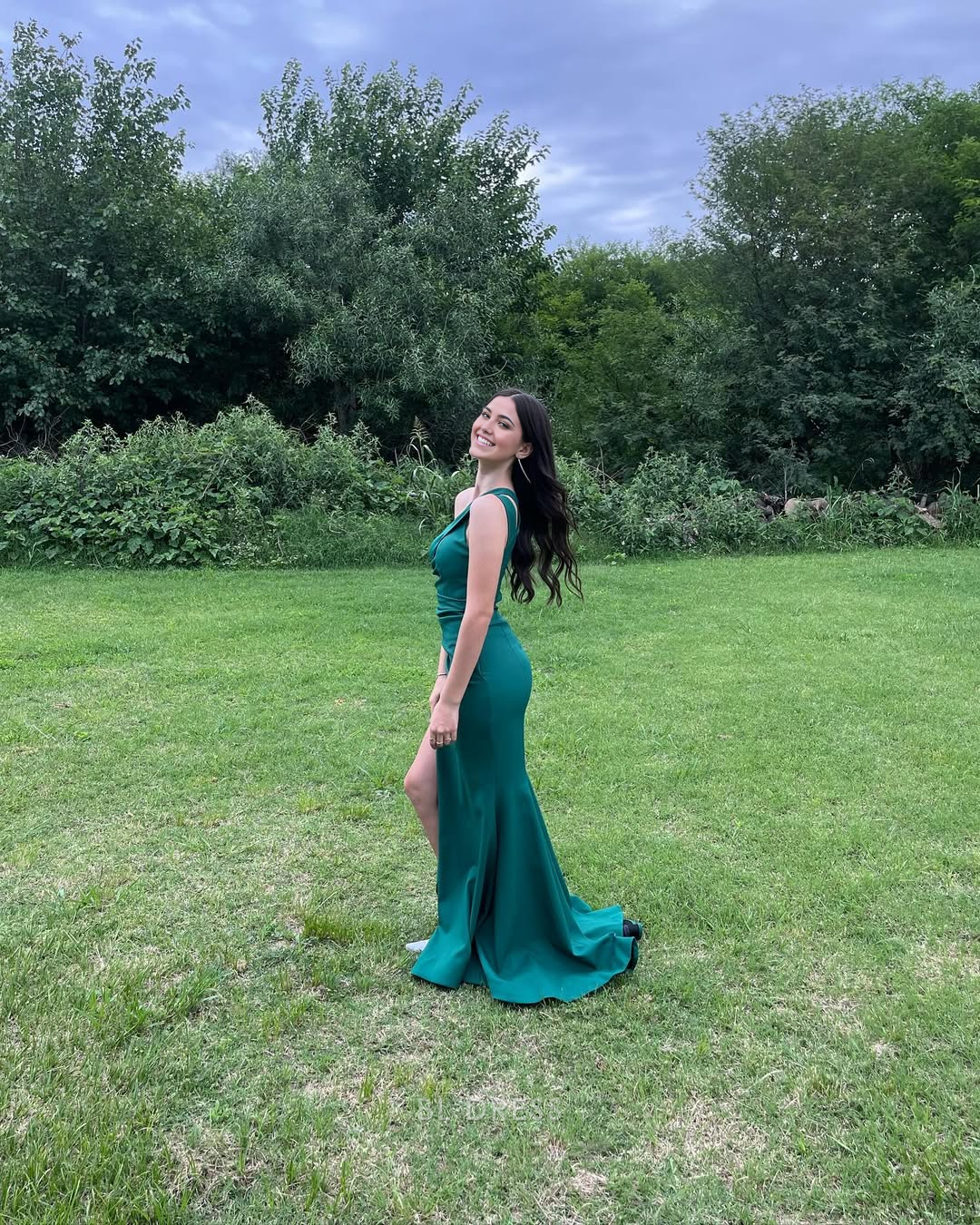 Back view of the emerald green one-shoulder mermaid gown.