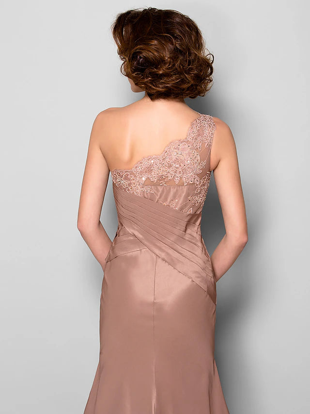 Detail of the one-shoulder neckline and floral embellishment.