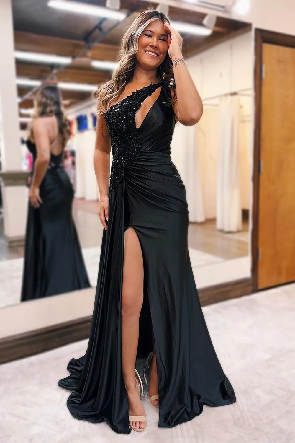 Elegant black mermaid one-shoulder satin gown with sparkling beading.