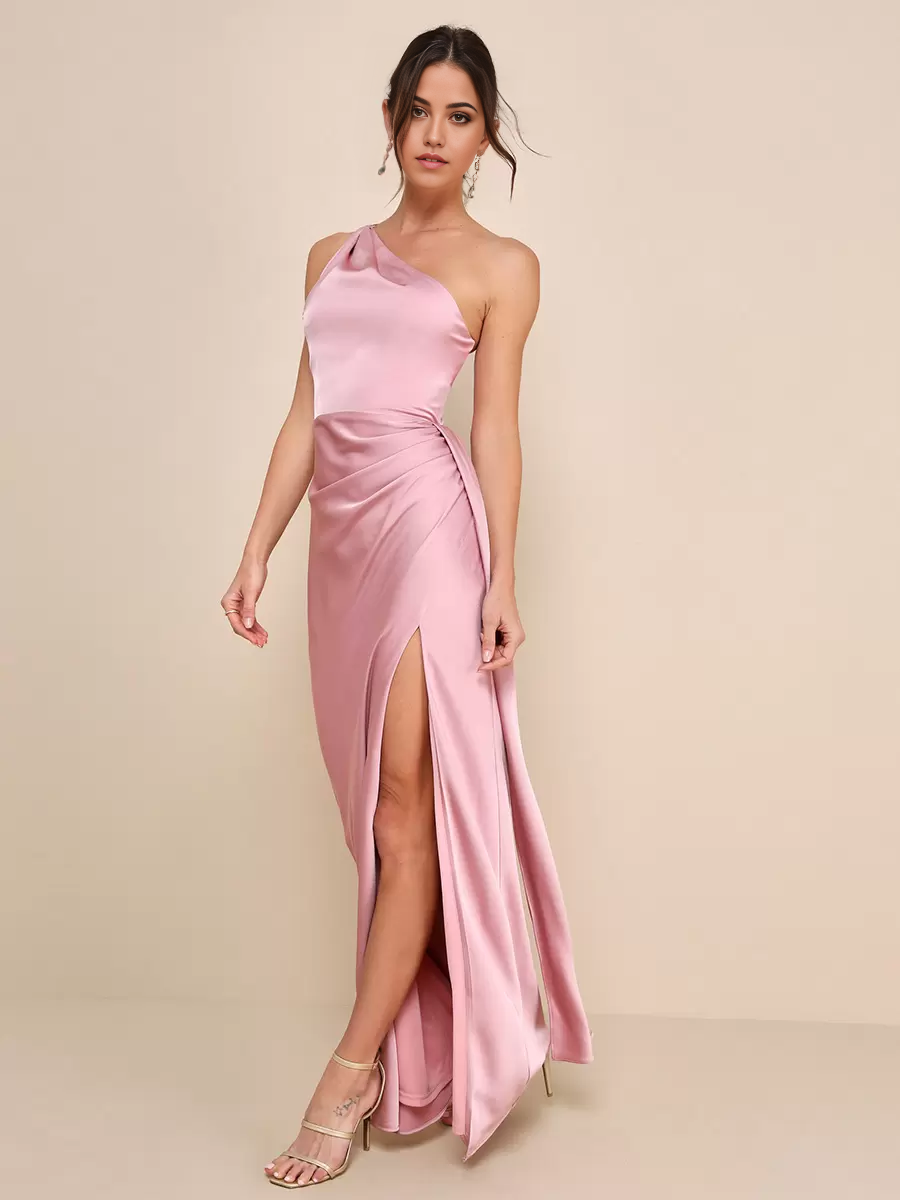 Woman in elegant mermaid one-shoulder ruched formal dress with high slit.