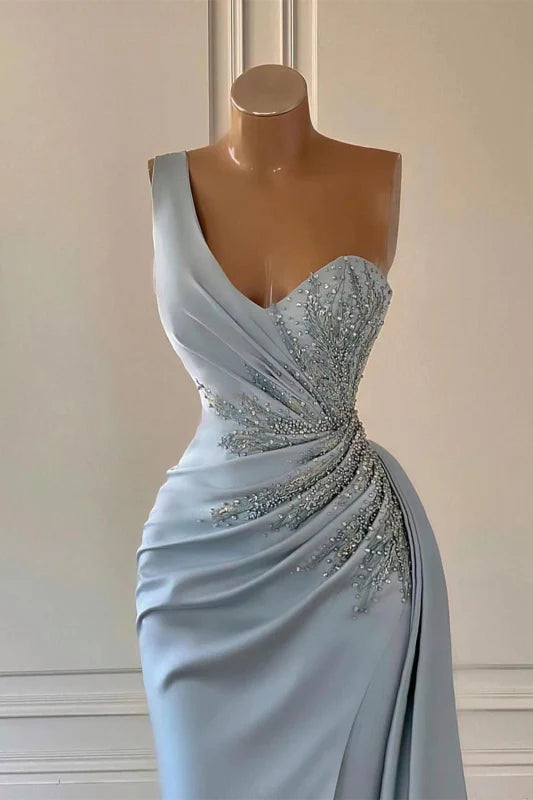 Back view of a woman in a ruffled mermaid one-shoulder formal gown.