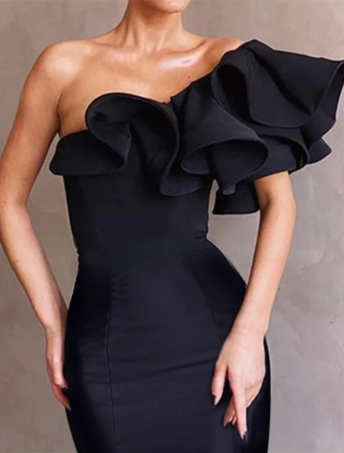 Close-up of the ruffled one-shoulder detail on a taffeta dress.