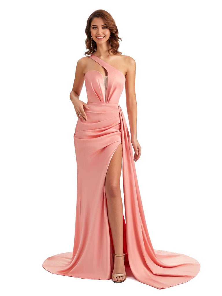 Woman wearing an elegant one-shoulder mermaid satin gown with a side slit.