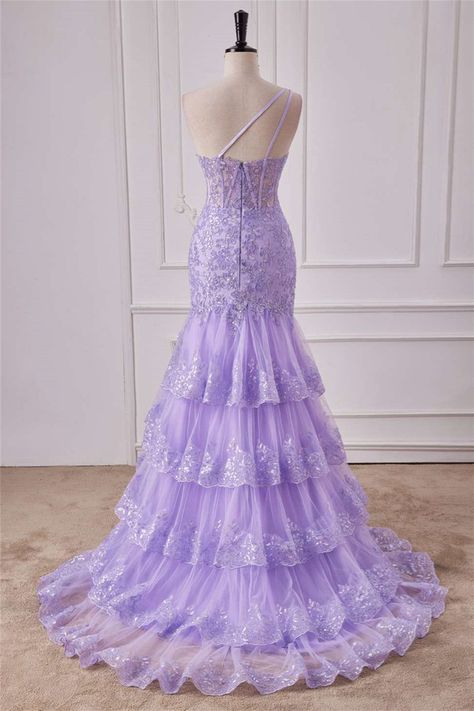 Close-up of violet purple sequin fabric on a one-shoulder prom dress.