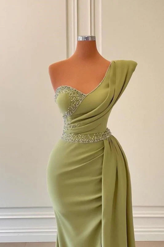 Back view of a mermaid one-shoulder prom dress with delicate beadings.