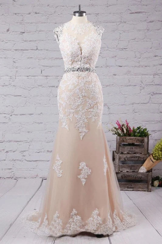 Elegant mermaid wedding dress with a sweep train and open back, adorned with appliques.