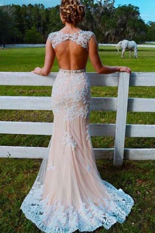 Back view of a mermaid prom dress showcasing the open back and tulle appliques.