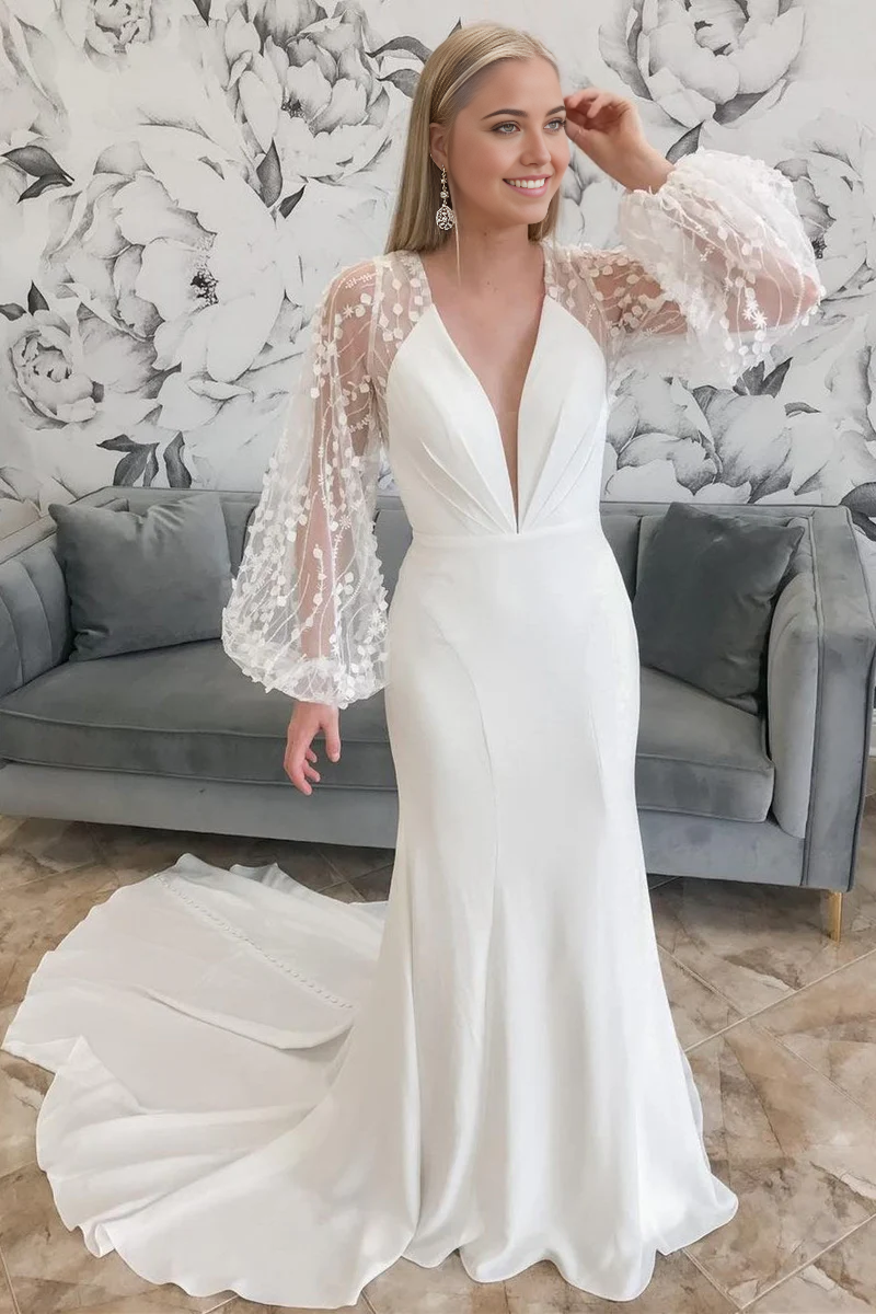 Elegant mermaid wedding dress with plunge V-neck and balloon sleeves.