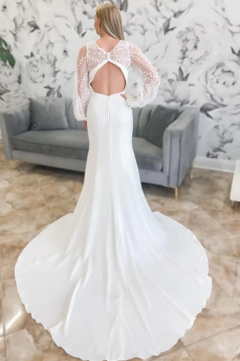 Close-up of the balloon sleeves on a long wedding gown.