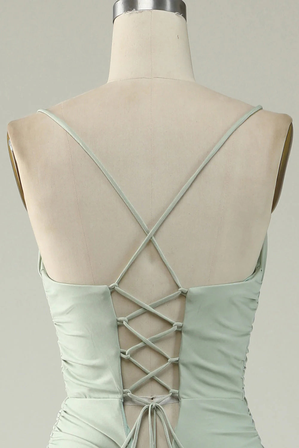 Back view of a light green mermaid dress, showing the elegant silhouette.