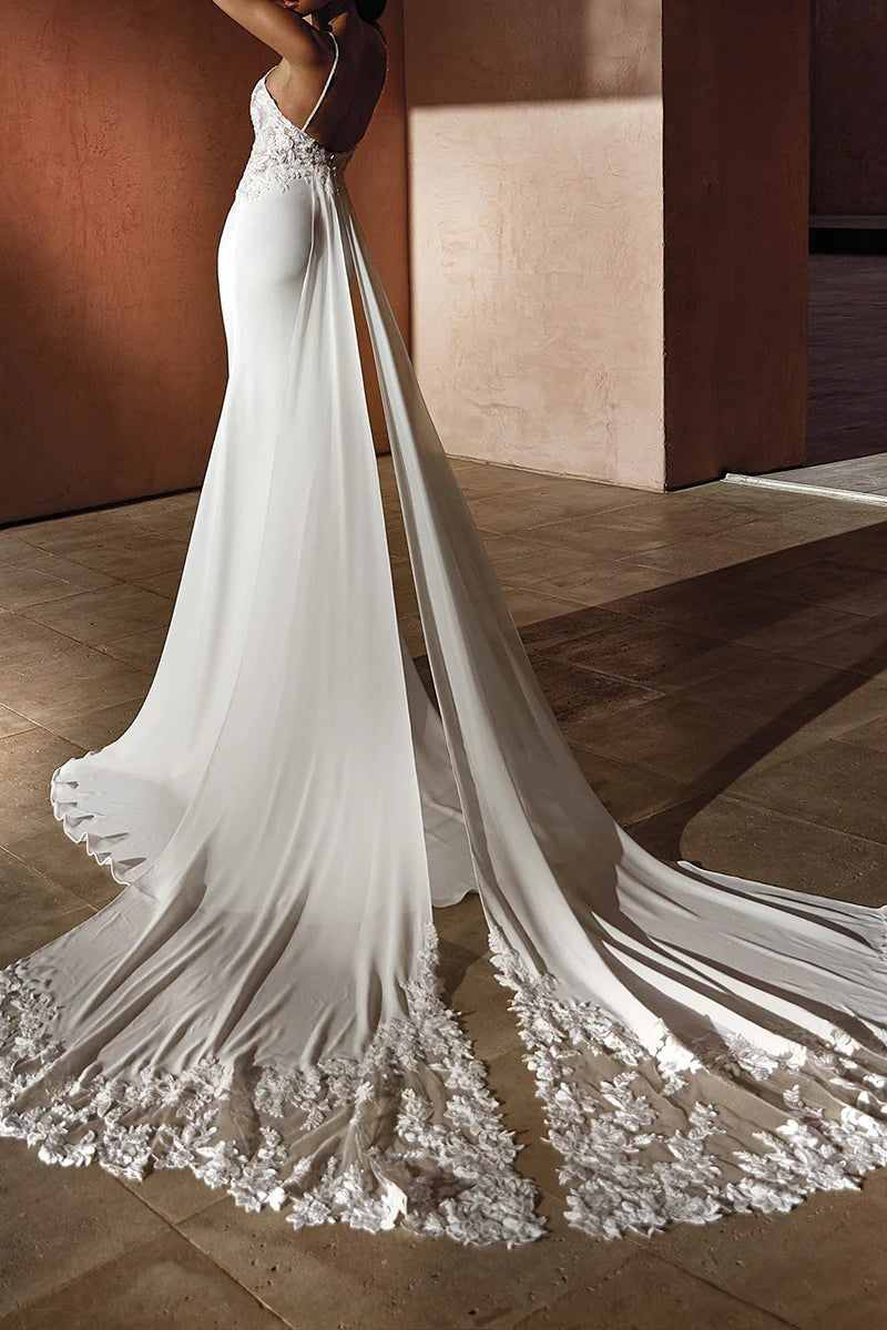 Back view of the mermaid wedding dress, showcasing lace details and train.