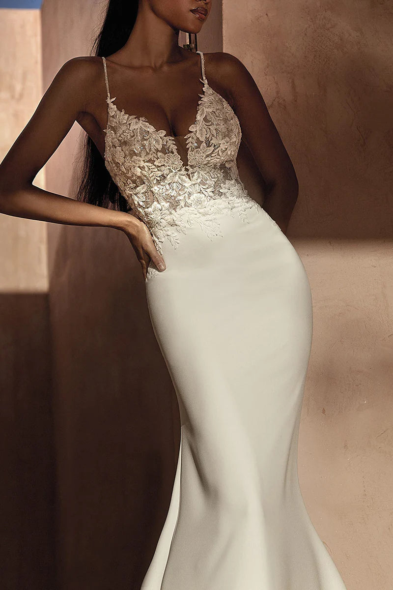 Close-up of delicate lace appliques on the wedding dress.
