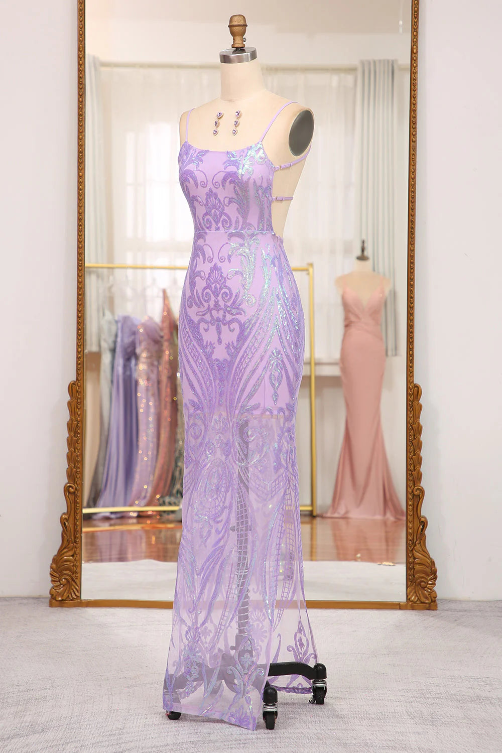 Side view of a model showcasing the mermaid silhouette of a formal gown.