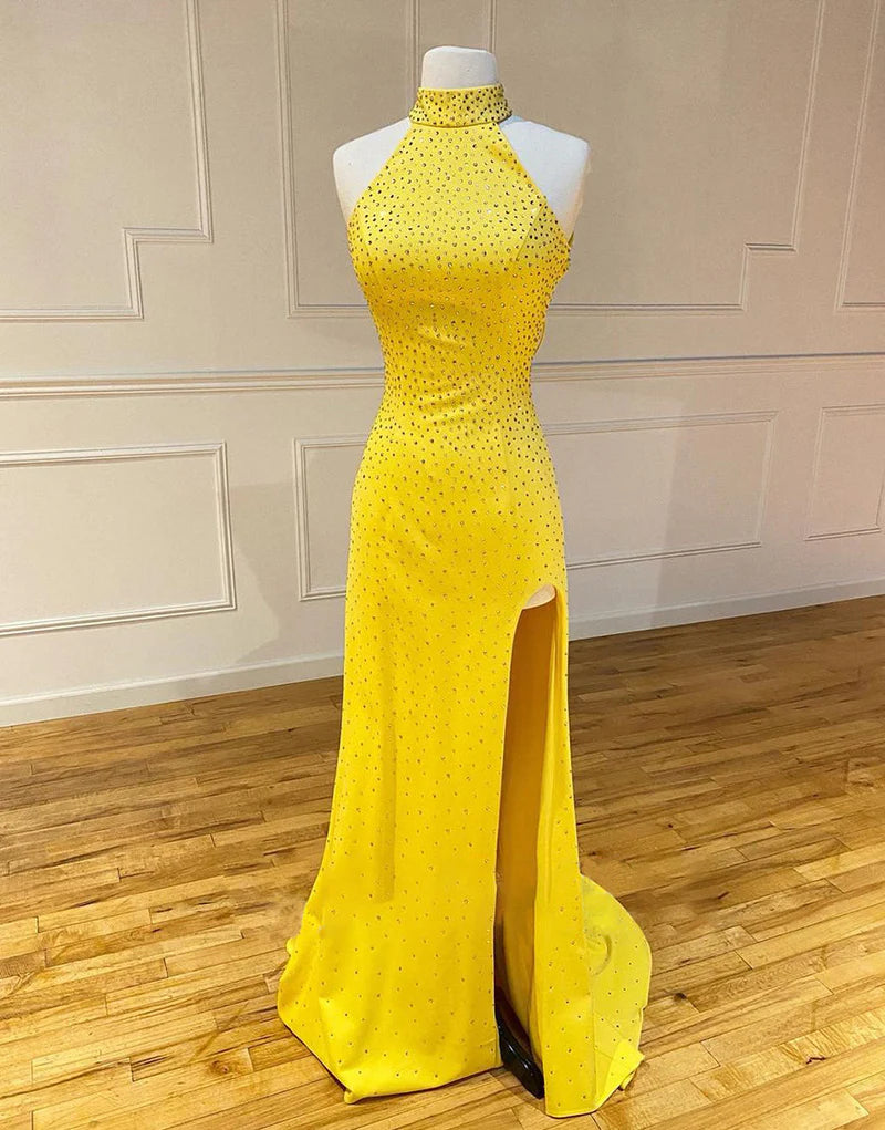 Woman wearing an elegant mermaid prom dress with a high leg split.