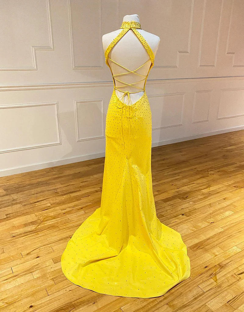 Full view of a woman in a sophisticated mermaid evening gown with a split.