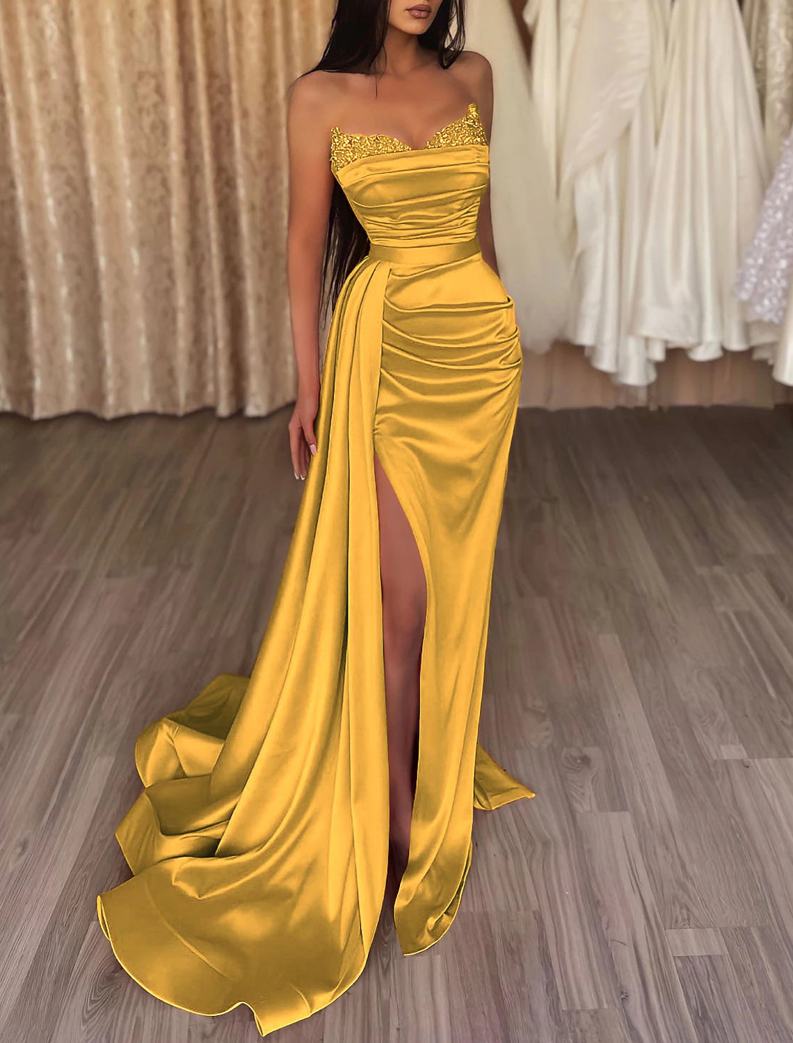 Close-up of the ruched bodice and intricate beading on the strapless satin gown.