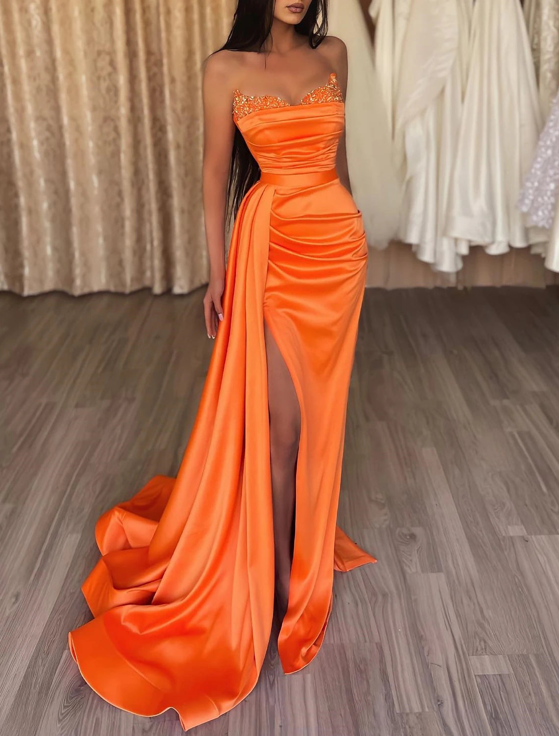 Detailed view of the court train and lower skirt of the mermaid ruched satin gown.