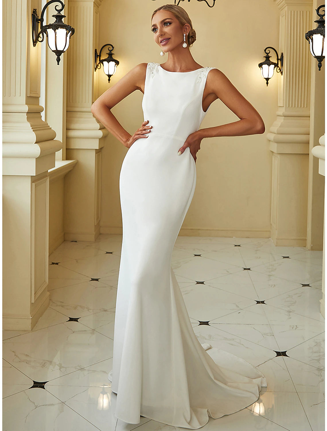 Elegant mermaid wedding dress with scoop neck and beading.