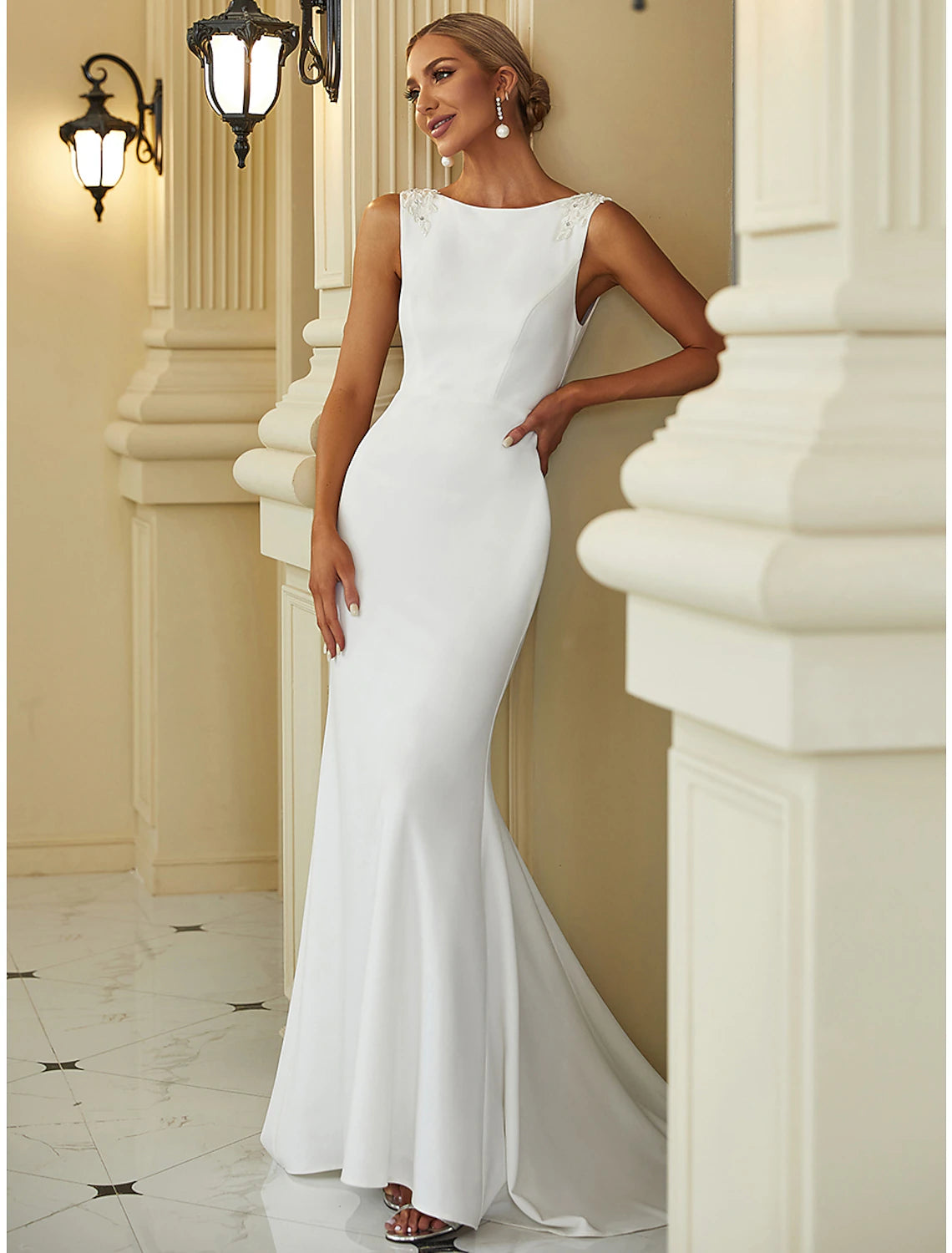 Side view of a mermaid wedding dress showing the sweep train.