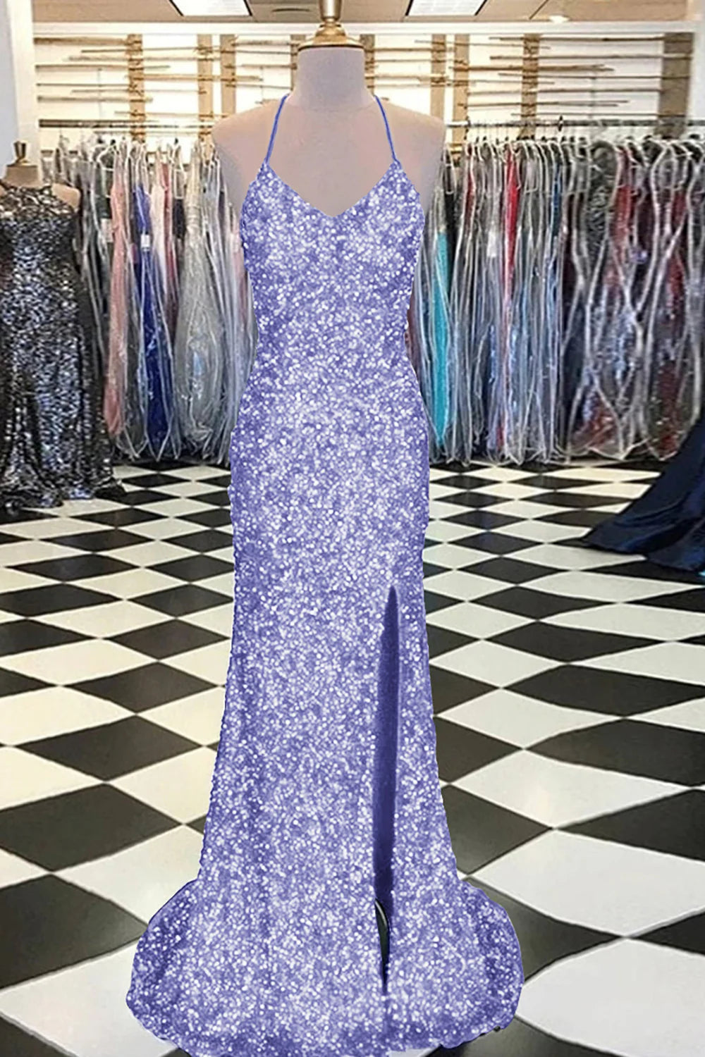 Woman in a light blue mermaid sequin prom dress, standing gracefully.