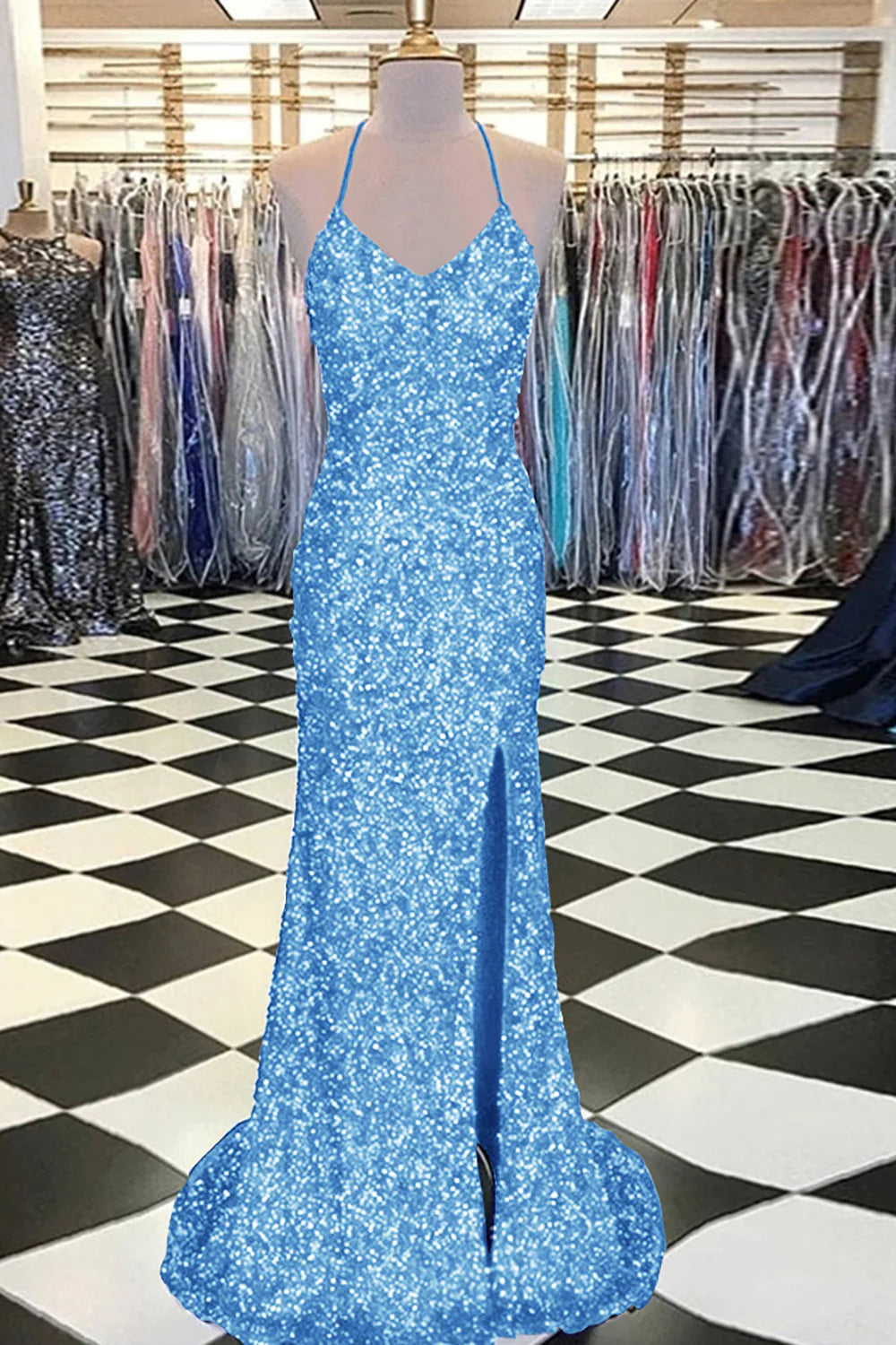 Woman in a fuchsia mermaid sequin prom dress, showing the full length.