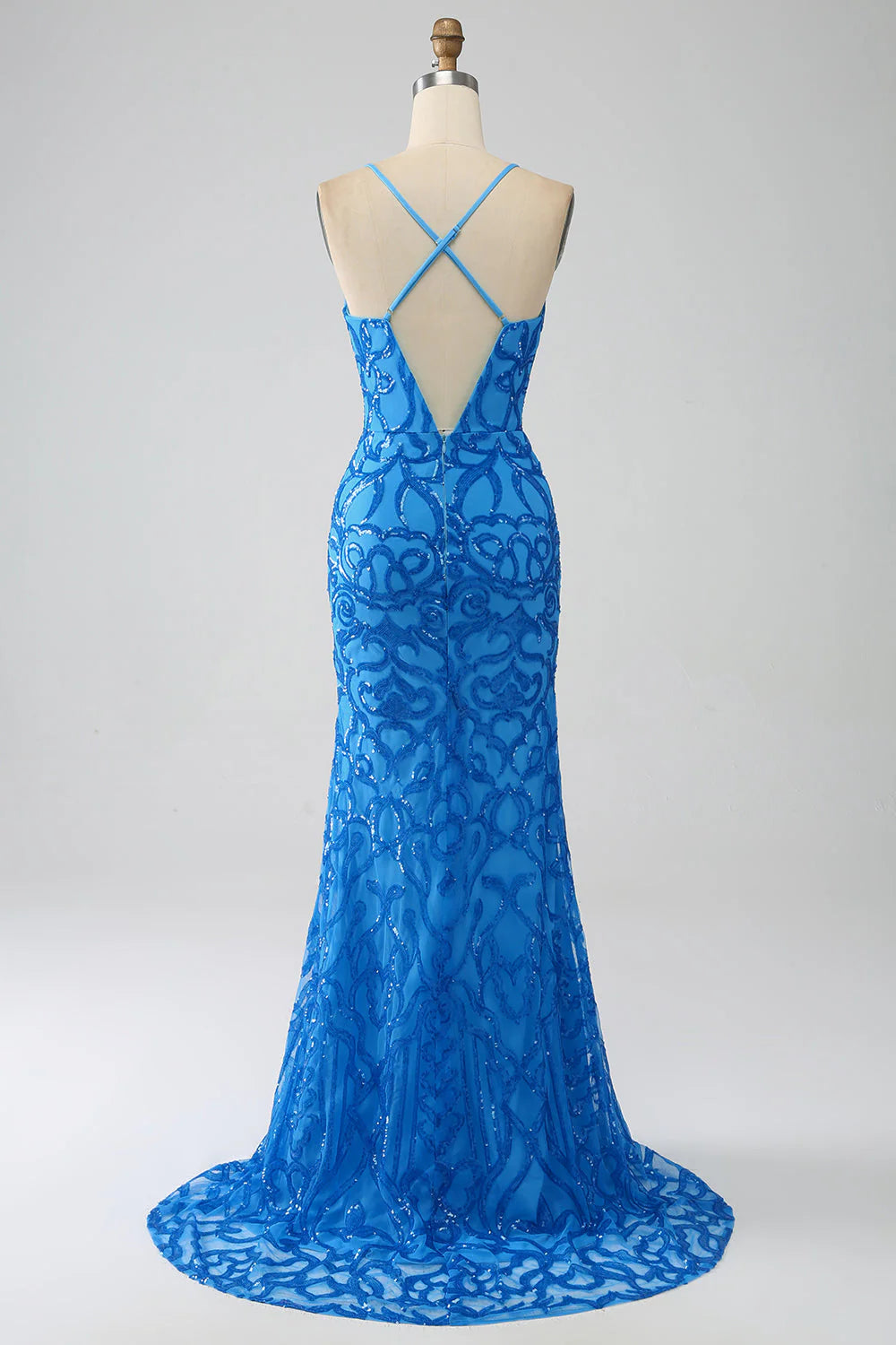 Woman wearing a blue mermaid sequin spaghetti strap formal dress.
