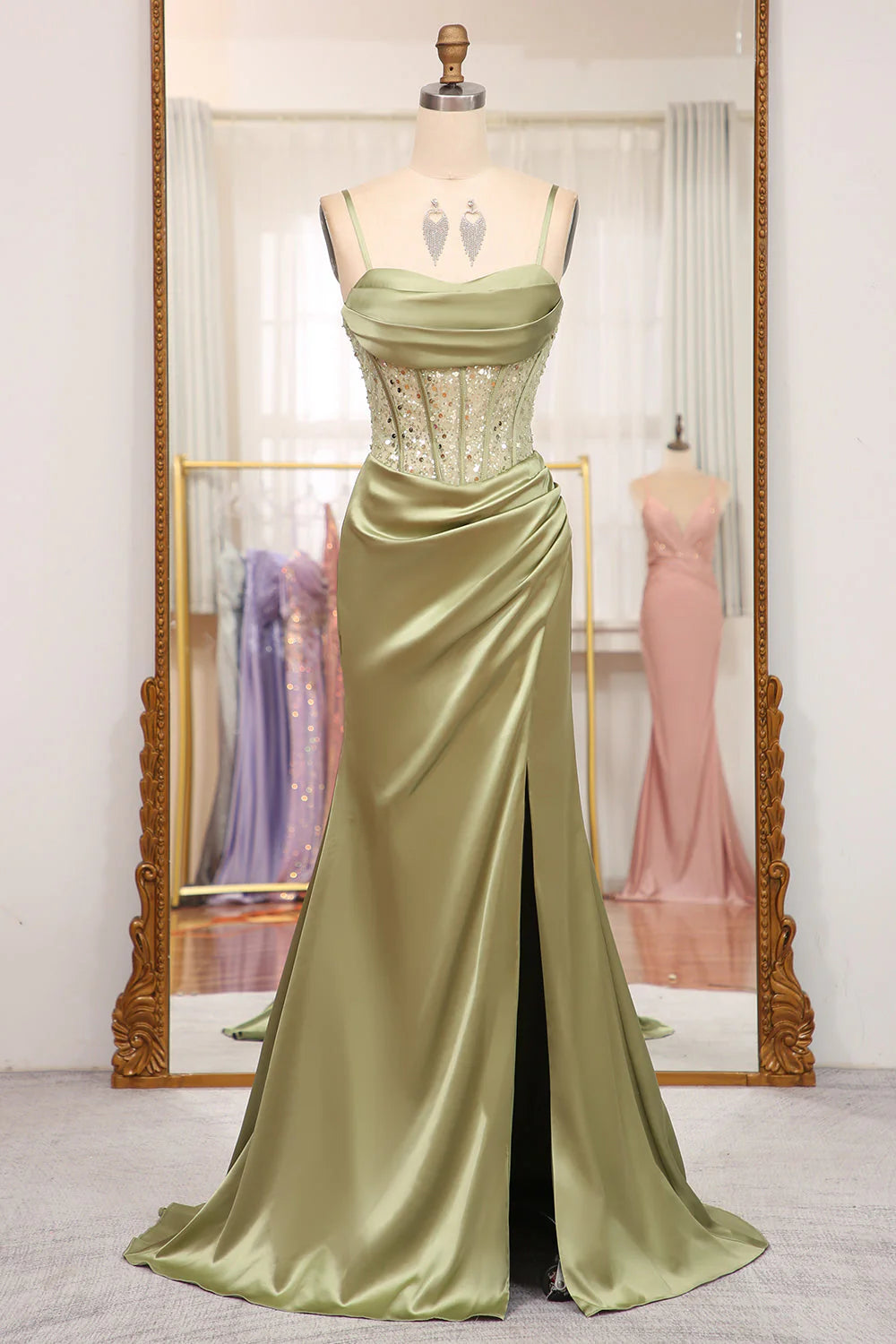Model wearing an elegant mermaid sequined prom dress with a corset bodice and high slit.