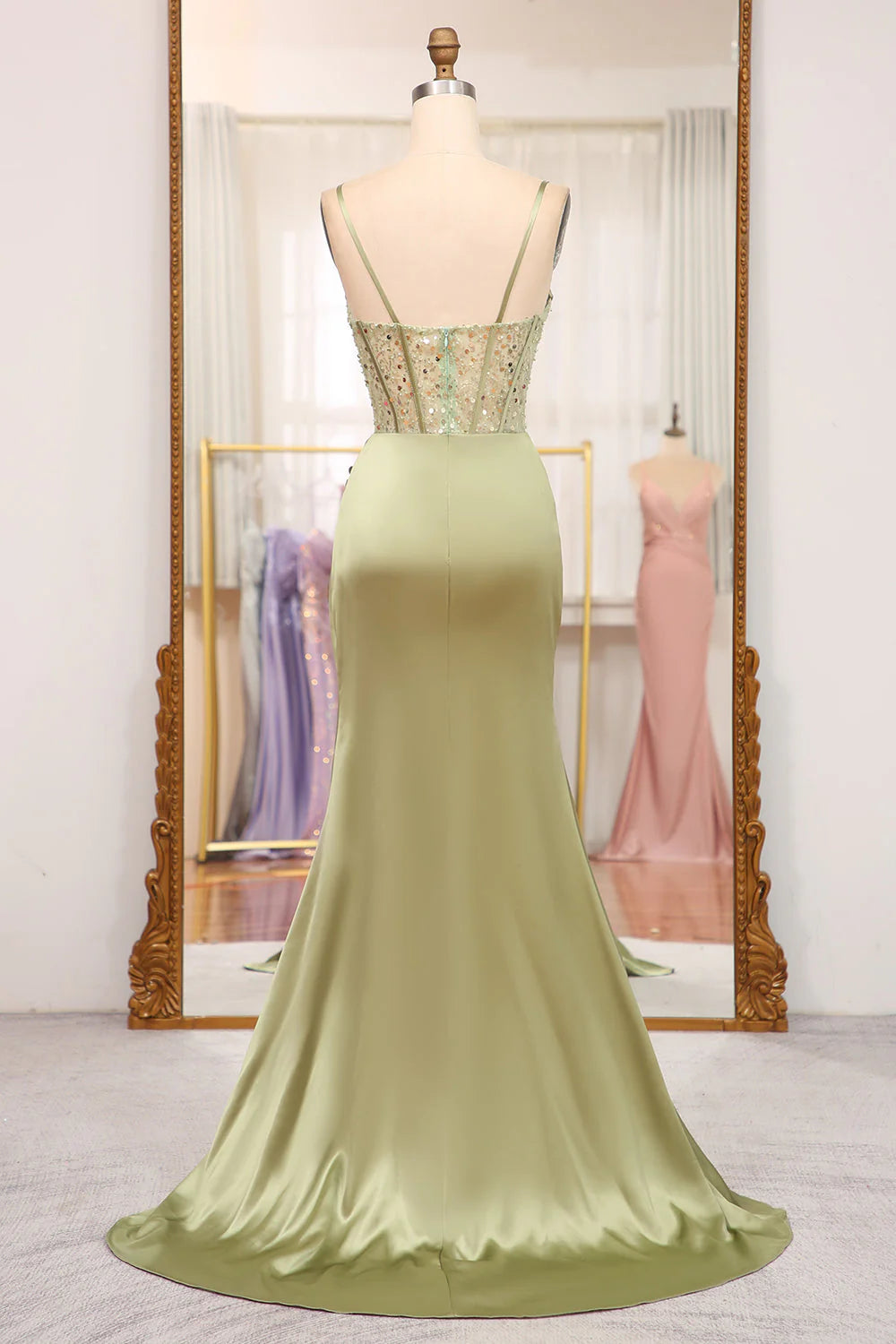 Back view of a model in a sequined mermaid dress, showcasing the corset detailing.