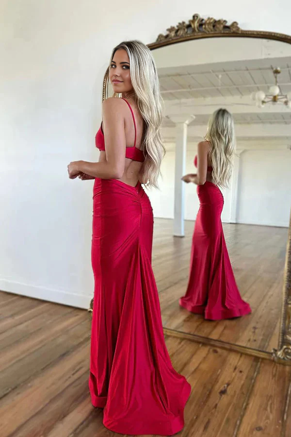 Side view of a woman wearing a satin mermaid sheath prom dress.