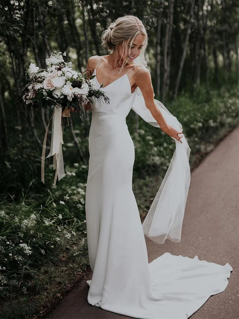 White mermaid wedding dress with V-neck and spaghetti straps.