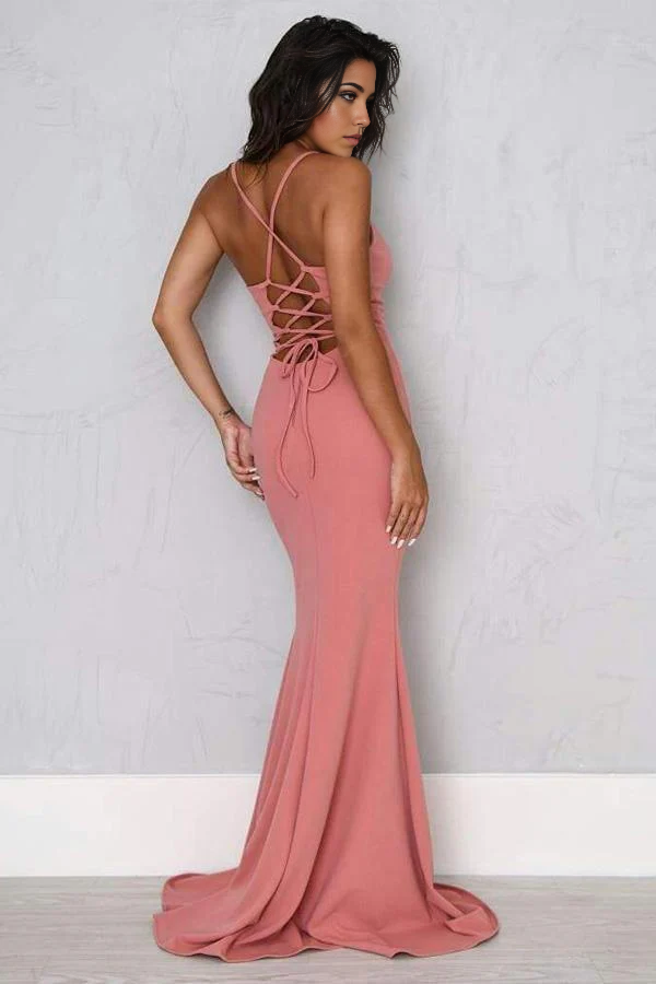 Full view of a woman in a long, dark mermaid formal dress with a V-neck and leg split.
